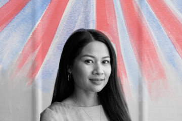 A black and white image of a woman smiling at the camera against a light wall. An illustration of red and blue sunbeams overlays the image.