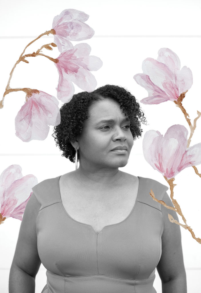 A black and white photo of a woman with short curly hair standing against a white wall. Illustrations of light pink magnolia flowers overlay the image.